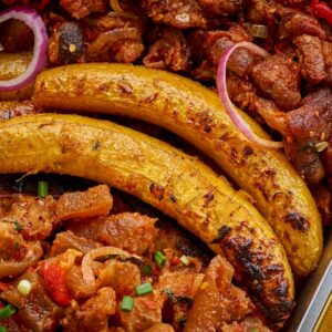 Asun, cow leg and grilled plantain and pepper sauce